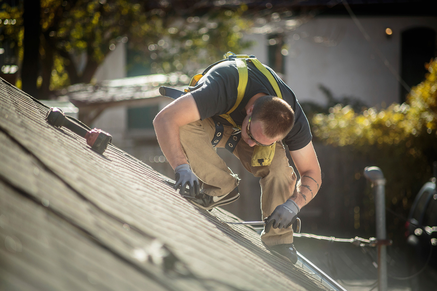 A roofer works on a residential home